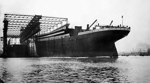 Titanic slips into the Victoria Channel as she launches from the slipway at the Harland & Wolff shipyard.