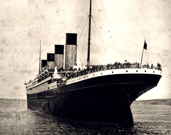 Titanic leaving Southampton at the beginning of her maiden voyage, with passengers gathered on deck